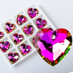 Detailed macro view of vibrant pink heart-shaped crystal pendants for DIY jewelry making.