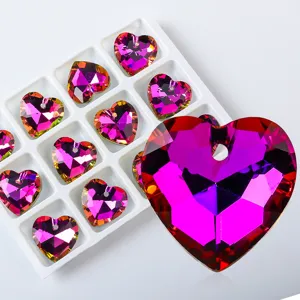 Close-up of faceted heart-shaped crystal pendants for DIY jewelry making.