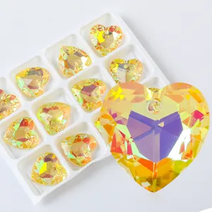 Macro view of iridescent yellow heart-shaped crystal pendant for DIY jewelry making