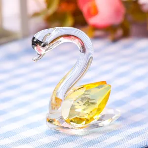 Close-up of an elegant crystal swan figurine with yellow faceted wings for home decoration