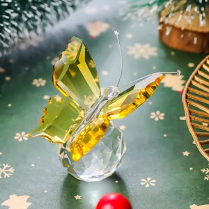 Macro detail of yellow faceted crystal butterfly on a clear crystal sphere base