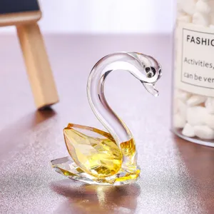Elegant crystal swan figurine featuring a faceted yellow body and clear glass neck detail