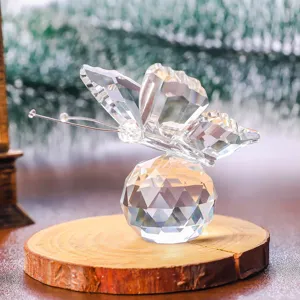 Macro view of a faceted crystal butterfly ornament perched on a rustic wooden base