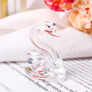 Detailed macro shot of an elegant clear crystal swan figurine with faceted cut details