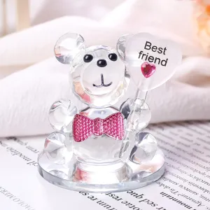 Macro view of a crystal teddy bear figurine holding a Best friend heart balloon