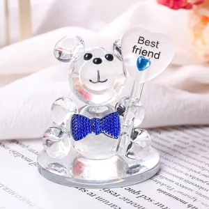 Decorative clear crystal bear figurine with blue bowtie holding a Best friend heart