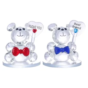 Detail of crystal bear figurines holding heart signs with I LOVE YOU and Best Friend