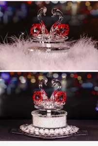 Detailed view of romantic crystal swan car ornament with red accents and pearl base