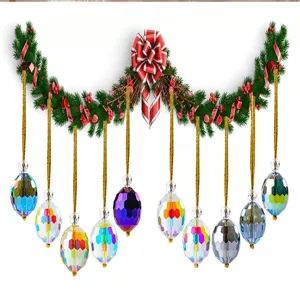 Detail view of 10 faceted colorful crystal Christmas tree ornaments with gold strings.