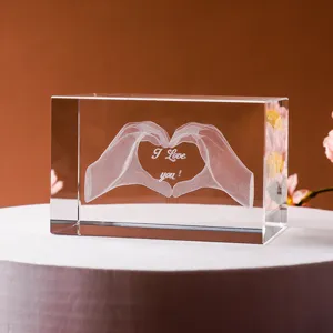 Vista detallada del bloque de cristal grabado con láser 3D con corazón de manos y texto I Love You