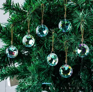Detailed macro view of crystal prism pendants reflecting light on a lush Christmas tree.