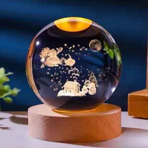 Close-up of a 3D laser engraved Christmas crystal ball night light on a wooden base