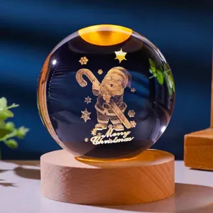 Detailed macro view of a warm glowing Christmas crystal ball with laser-engraved Santa Claus