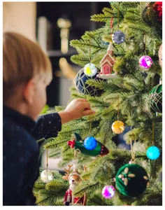 Close-up of faceted 30mm crystal ball ornaments hanging on a decorative Christmas tree