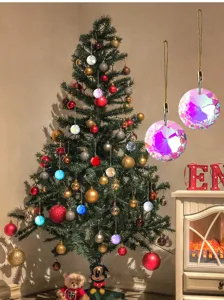 Close-up of 30mm faceted crystal prism ball ornaments hanging on a decorated Christmas tree.