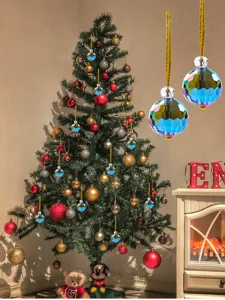 Close-up of faceted crystal Christmas ornaments hanging on a decorated festive tree