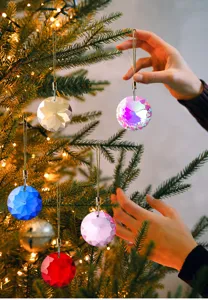 Close-up macro view of multi-colored faceted 30mm crystal ornaments on a Christmas tree