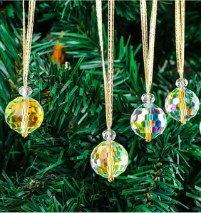 Detailed macro view of faceted iridescent crystal Christmas tree ornaments hanging on branches