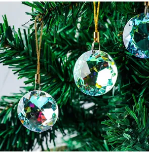 Close-up of 30mm faceted crystal prisms hanging on a green Christmas tree branches