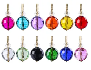 Detail view showing 12 different colors of faceted crystal Christmas tree ornaments.