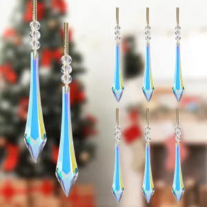 Detailed macro view of iridescent crystal icicle Christmas tree ornaments set with gold cords.