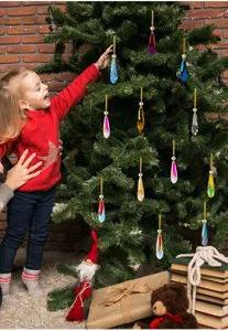 Close-up of colorful crystal drop ornaments hanging on a Christmas tree during holidays