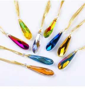 Detail view of faceted crystal teardrop Christmas tree ornaments in various vibrant colors.