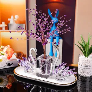 Elegant K9 crystal swan pair with amethyst tree ornament on a gold-rimmed tray
