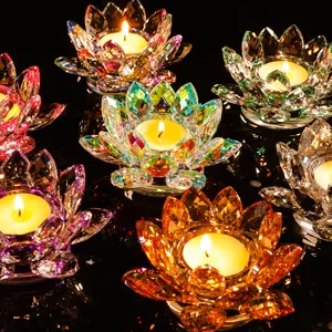 Vibrant colorful crystal lotus tea light candle holders on a dark reflective surface.