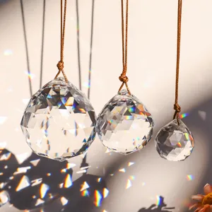Close-up of faceted K9 crystal balls hanging with rainbow prism reflections