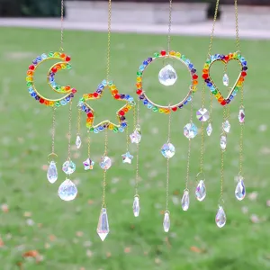 Detailed view of rainbow crystal sun catchers with moon star and heart pendants