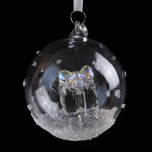 Clear crystal ball car rearview mirror pendant with interior bow and snowflake details.