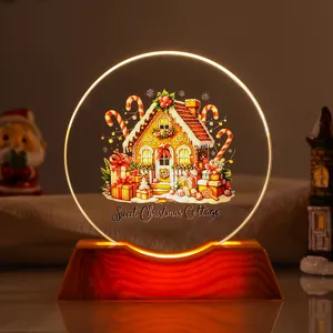 Close-up of a warm LED Christmas cottage night light with wooden base