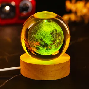 Macro view of 3D laser engraved moon crystal ball night light with wooden base