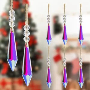 Detail of faceted iridescent crystal Christmas ornaments hanging on golden strings