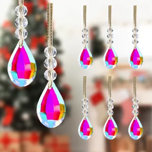 Detailed view of faceted teardrop crystal Christmas ornaments with rainbow AB coating