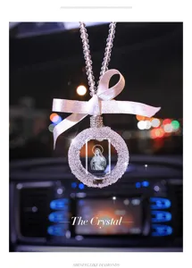 Close-up of 3D laser engraved crystal car pendant with Virgin Mary and pink ribbon