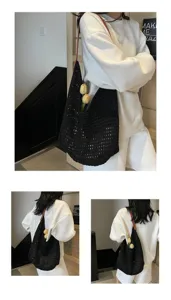 Side view of a black hollow-out knitted shoulder bag worn by a model in a white sweatshirt.
