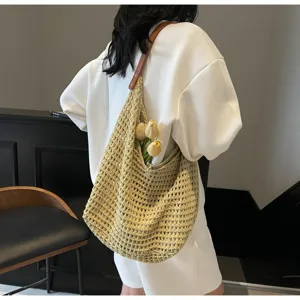 Back view of person carrying large woven knit mesh bag with tulips in lifestyle setting
