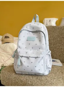 Detail of light blue school backpack with silver heart pattern and LXINDA label.