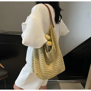 Detailed side view of large capacity hollow knit woven mesh shoulder bag with flowers