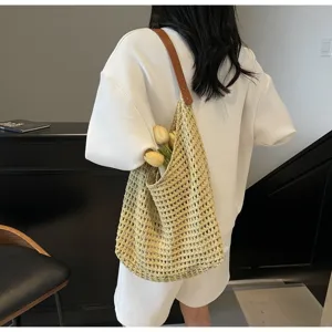 Lifestyle view showing the mesh texture of a knit hobo bag with a brown leather strap