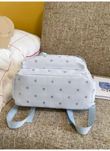 Bottom view of a light blue casual backpack featuring a silver heart pattern detail