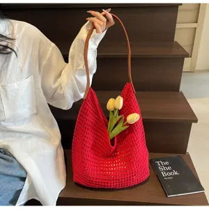 Red knit crochet shoulder bag with hollow mesh design, brown strap, and tulip accent