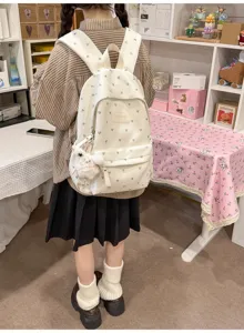 Cream white school backpack with heart print and a cute rabbit plush charm detail