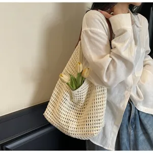 Close-up detail of the beige hollow knit texture and side pocket of the woven shoulder bag