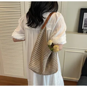 Stylish summer knit crochet hobo bag with hollow mesh design and brown leather strap