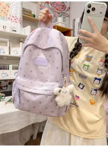 Lavender purple backpack with heart patterns shown being carried by a student