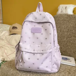 Lightweight purple casual backpack with silver heart pattern for school or commuting.