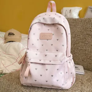 Casual lightweight pink student backpack featuring stylish silver heart prints for school